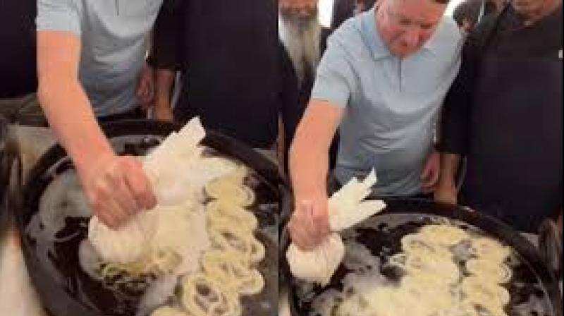 As he poured the batter into a large wok of hot oil, people around him cheered and recorded the moment. File Photo.