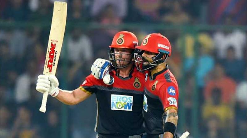 AB de Villiers celebrates his fifty runs with captain Virat Kohli
