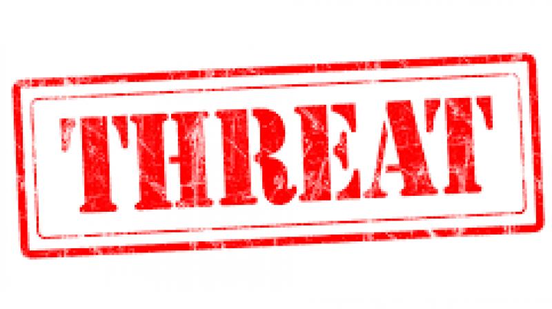 Man held for rape threat