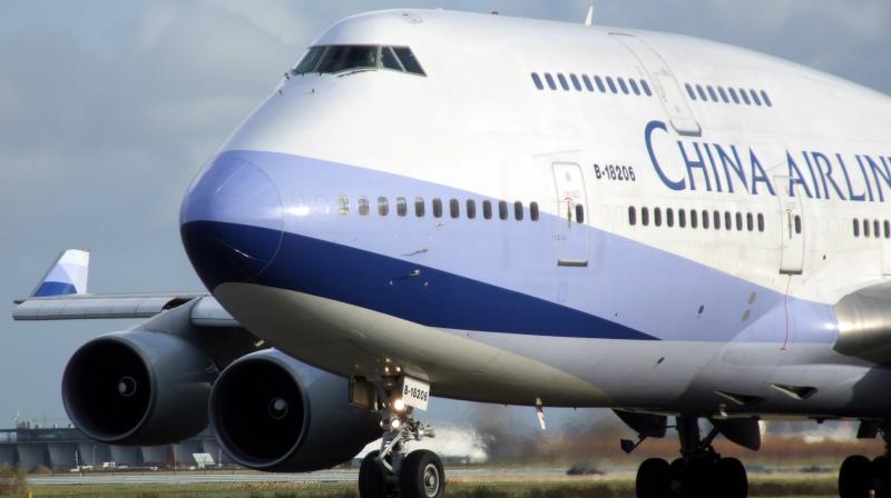 Chinese man detained after he opened the emergency exit on a plane