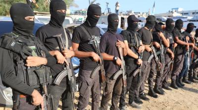 Palestinian militants stand guard as the hostages were being handed over to International Committee of the Red Cross in Khan Younis (Courtesy: The Reuters)