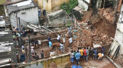 An elderly man and his grand child were killed after a wall collapsed